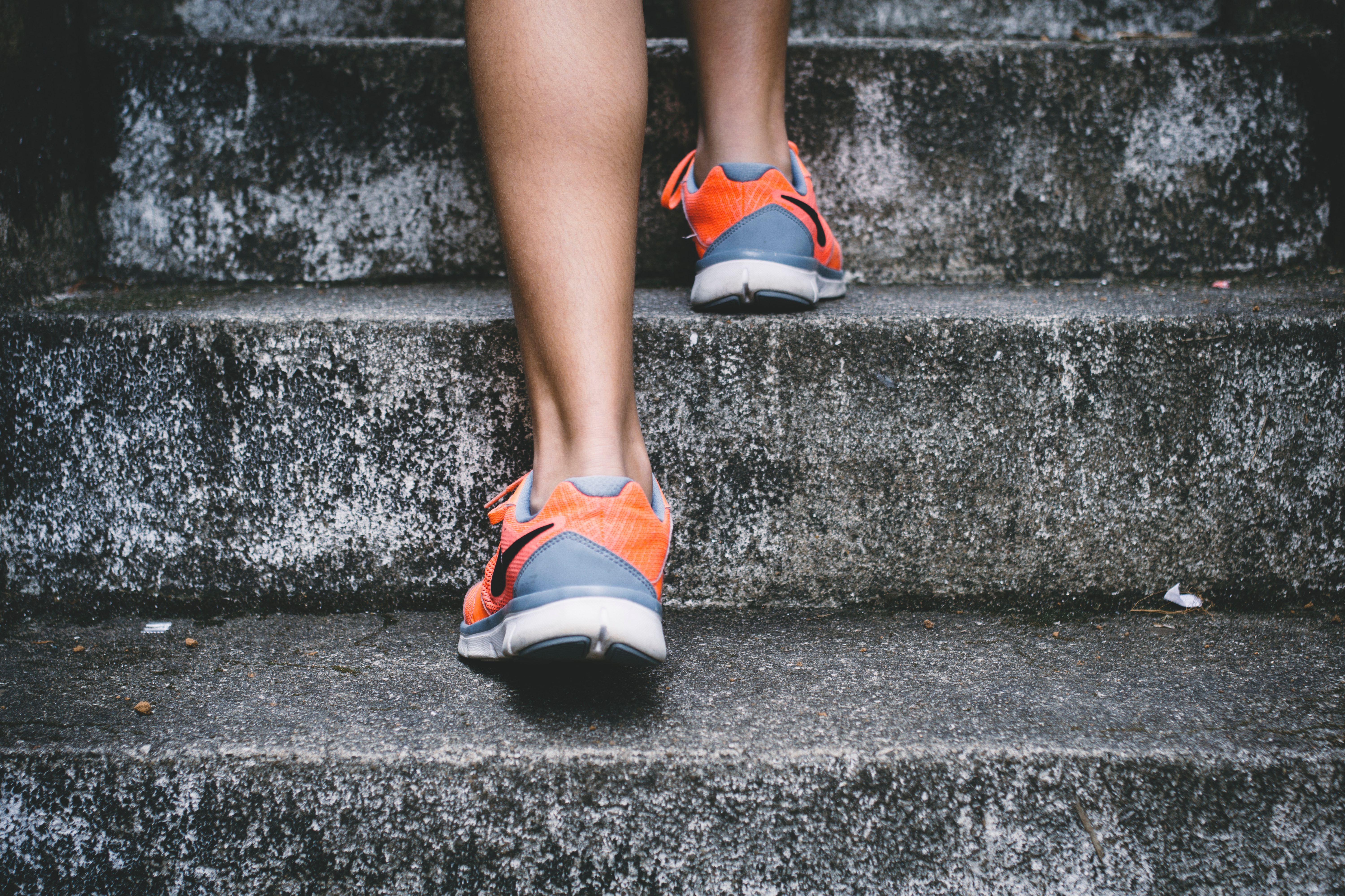 Close up of someone wearing trainers climbing steps