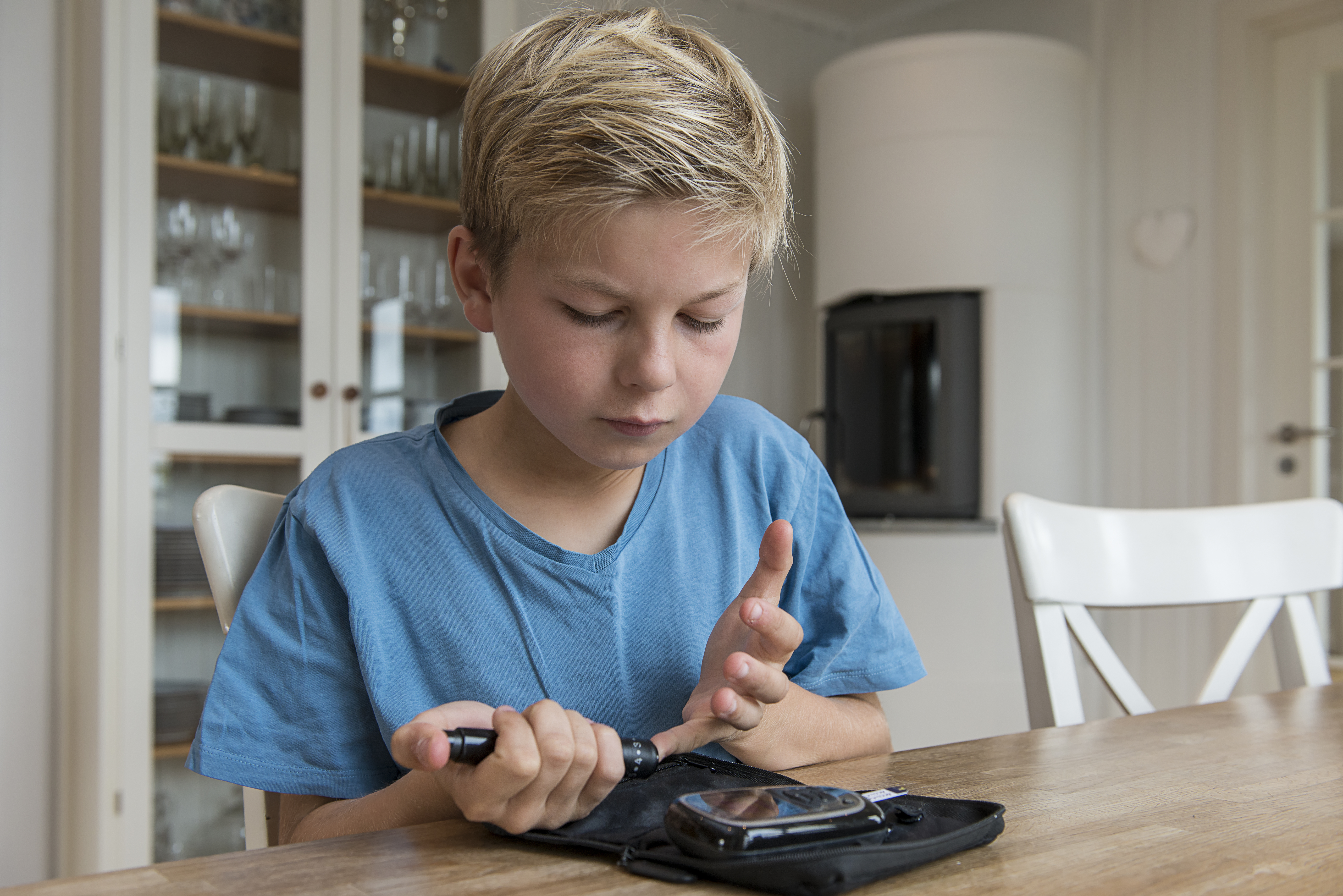 Young boy testing his blood sugar