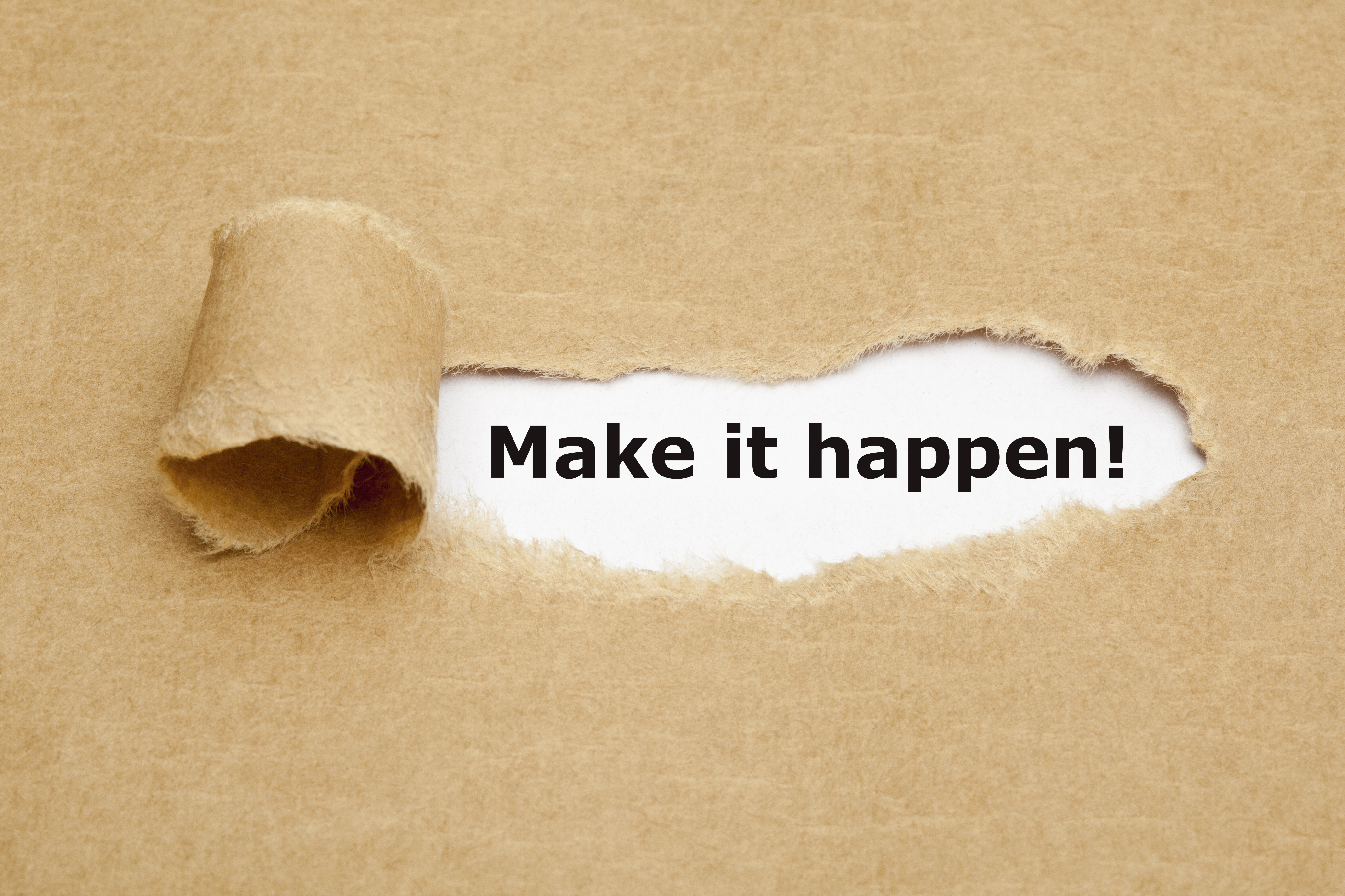Peeling paper with make it happen! written below