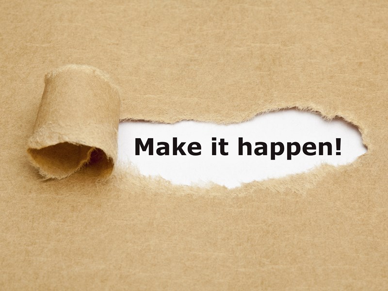 Peeling paper with make it happen! written below